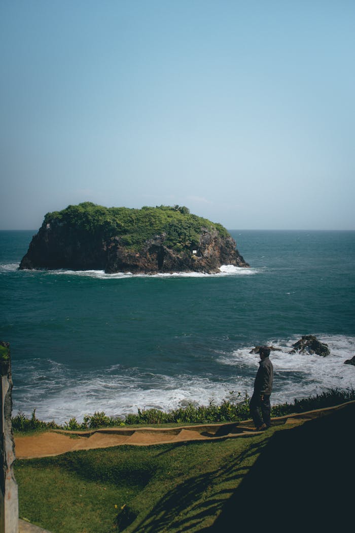 Peaceful scene of a distant island and ocean waves, ideal for travel inspiration.